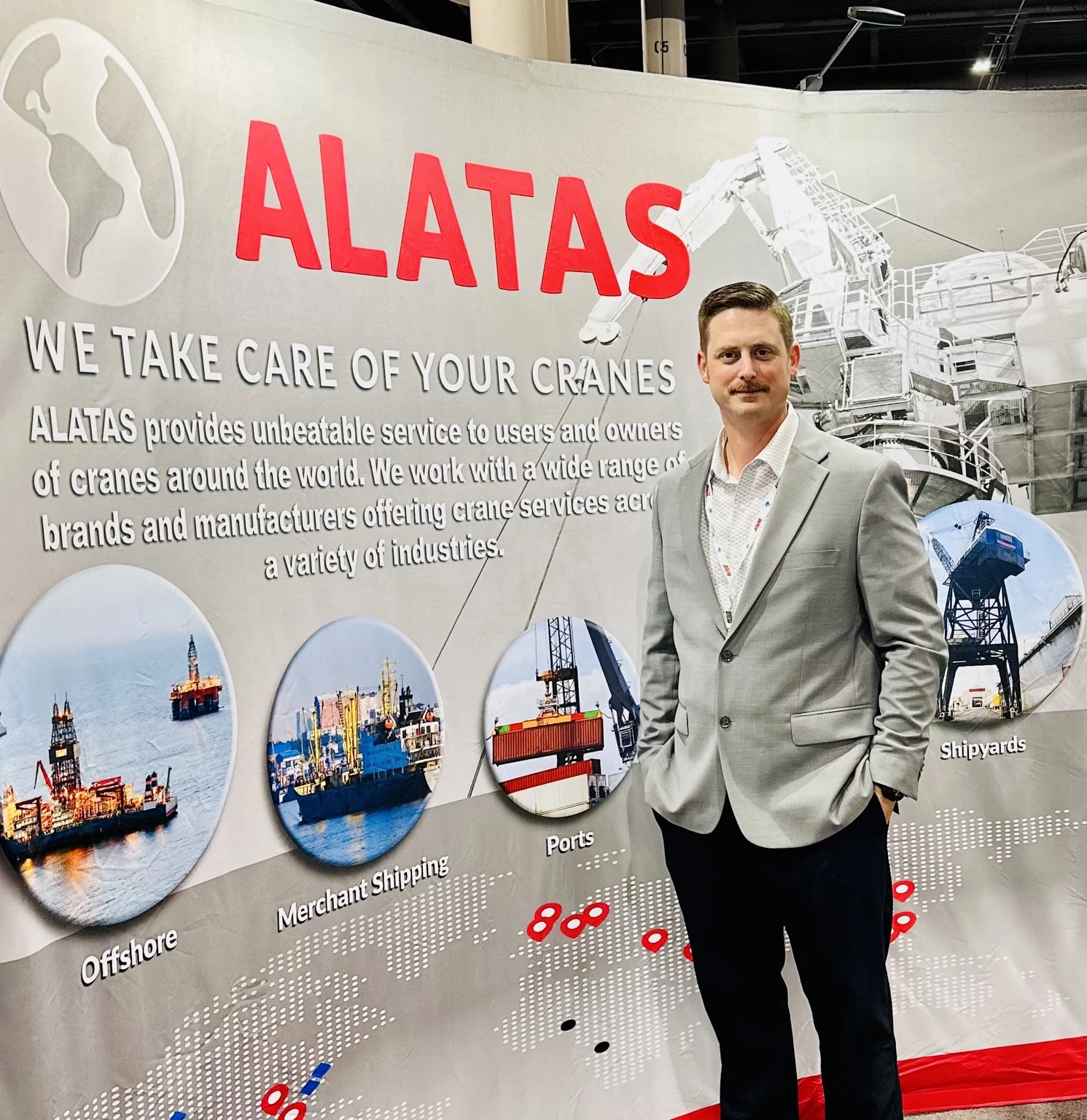 Kyle Dinsmoor standing at an ALATAS exhibition display